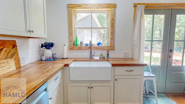 26 Cason Rd, Pembroke, GA 31321 - kitchen featuring french doors, dishwasher, white cabinetry, and wooden counters