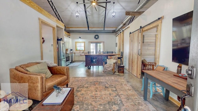 26 Cason Rd, Pembroke, GA 31321 - living room with a barn door and a ceiling fan