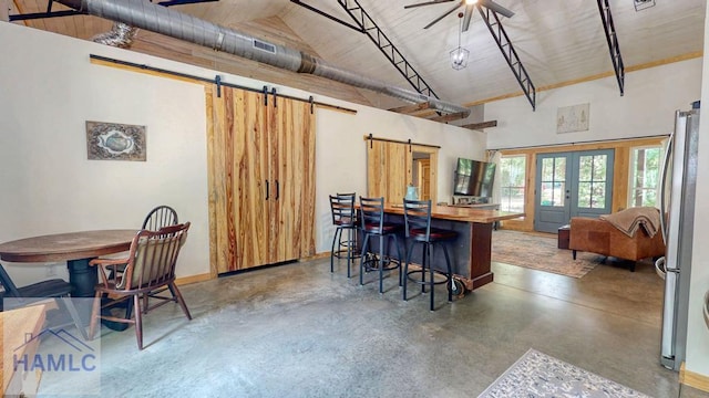 26 Cason Rd, Pembroke, GA 31321 - kitchen with a barn door, finished concrete floors, french doors, high vaulted ceiling, and freestanding refrigerator