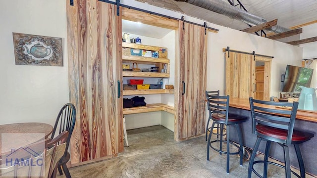 26 Cason Rd, Pembroke, GA 31321 - dining room with a barn door and concrete flooring