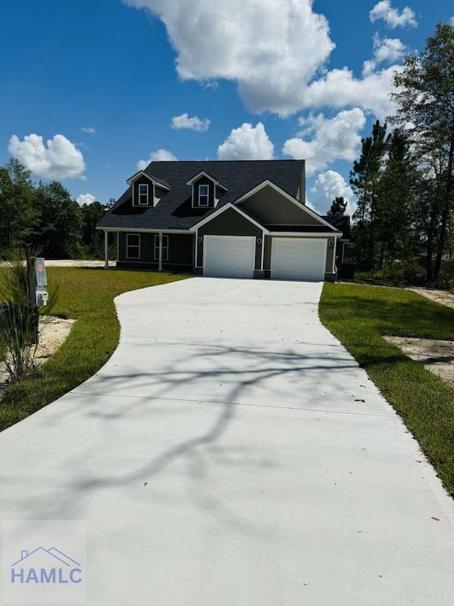 view of front of property featuring a garage and a front lawn