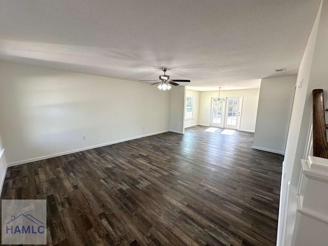 spare room featuring ceiling fan, dark hardwood / wood-style flooring, and a textured ceiling