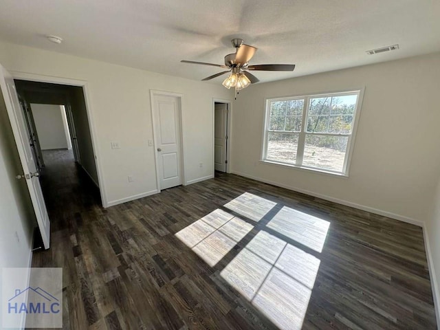 unfurnished bedroom featuring dark hardwood / wood-style floors and ceiling fan