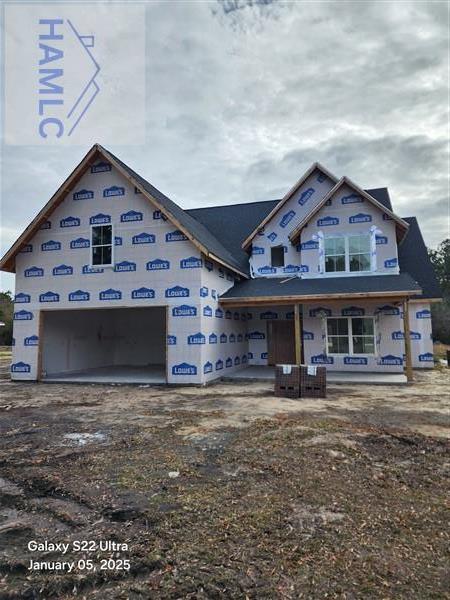 unfinished property with a porch and a garage