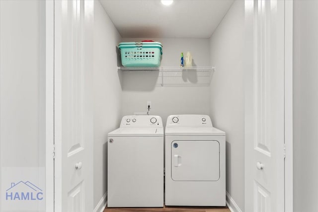 laundry room featuring baseboards, laundry area, and washer and clothes dryer