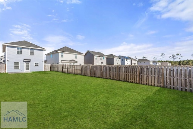 view of yard with a residential view and a fenced backyard