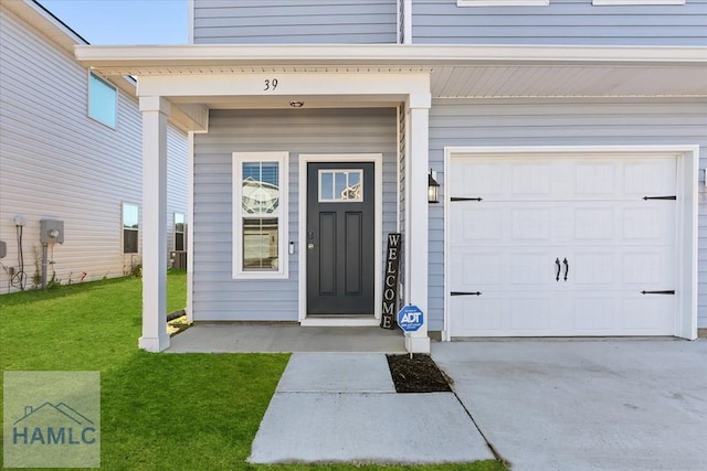 doorway to property with a yard and driveway