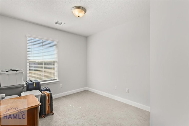 office area with visible vents, baseboards, carpet, and a textured ceiling