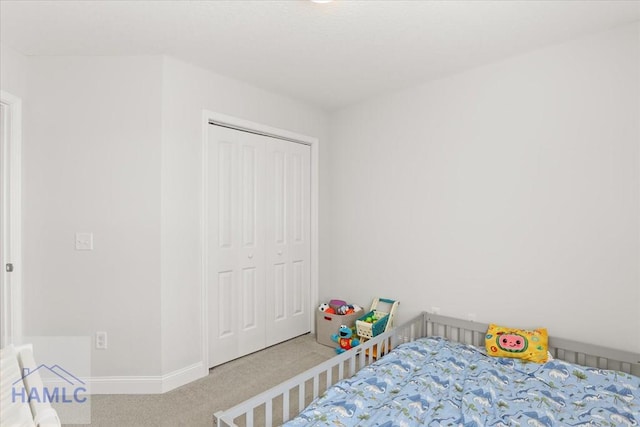 bedroom featuring carpet, a closet, and baseboards