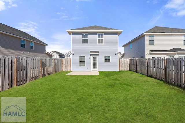 rear view of property with a patio, a lawn, and a fenced backyard