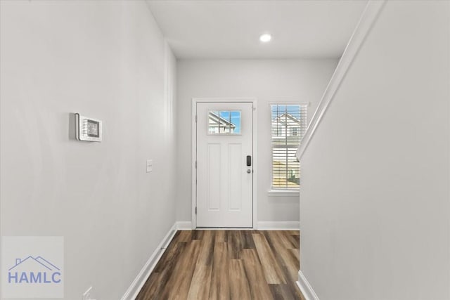 doorway to outside with recessed lighting, baseboards, and dark wood finished floors