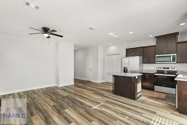 kitchen with dark brown cabinetry, visible vents, and appliances with stainless steel finishes