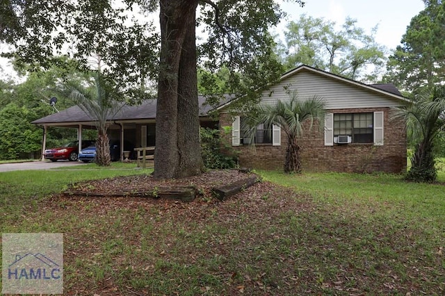 455 N Mahogany St, Jesup, GA 31546 - single story home with an attached carport, cooling unit, a front lawn, driveway, and brick siding