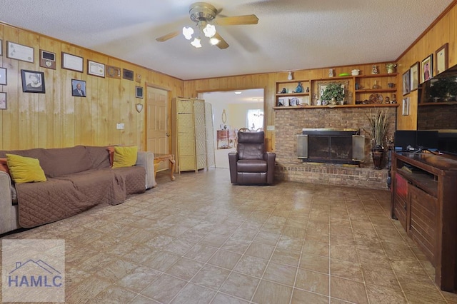 455 N Mahogany St, Jesup, GA 31546 - living room with wooden walls, a ceiling fan, a brick fireplace, and a textured ceiling