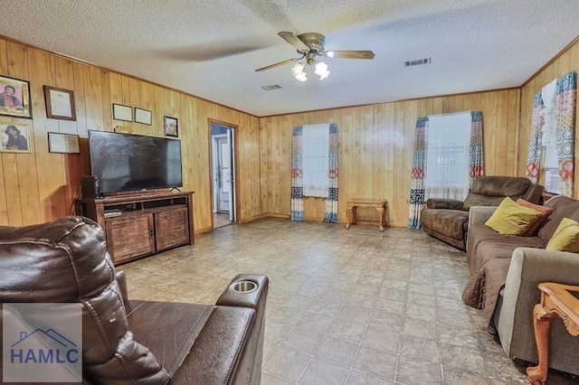 455 N Mahogany St, Jesup, GA 31546 - living area featuring wood walls, a ceiling fan, and a textured ceiling