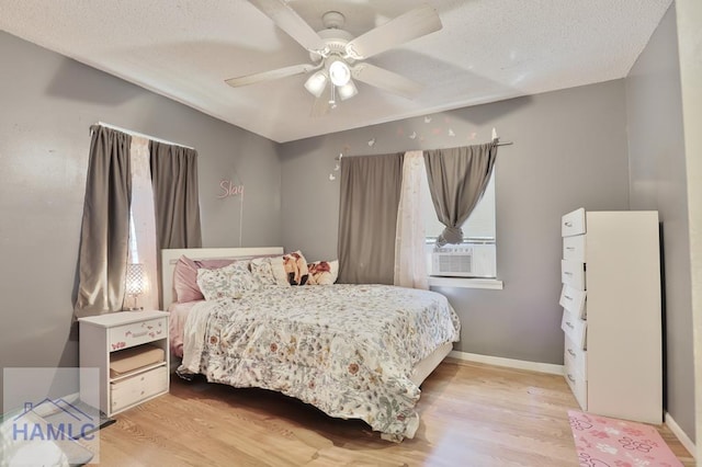 455 N Mahogany St, Jesup, GA 31546 - bedroom featuring cooling unit, wood finished floors, a textured ceiling, and a ceiling fan