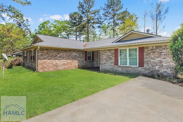209 Chandra Way, Hinesville, GA 31313 - rear view of house with a lawn, brick siding, and a shingled roof