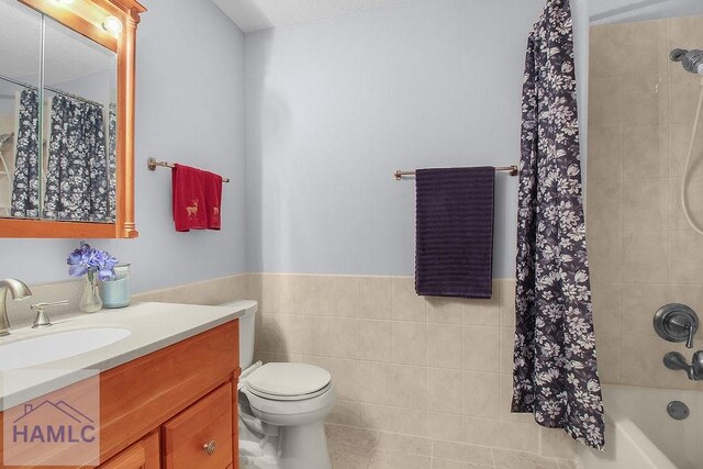 209 Chandra Way, Hinesville, GA 31313 - bathroom with vanity, wainscoting, shower / tub combo, toilet, and tile walls