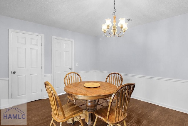 209 Chandra Way, Hinesville, GA 31313 - dining room with a chandelier, dark wood-style floors, a textured ceiling, and baseboards
