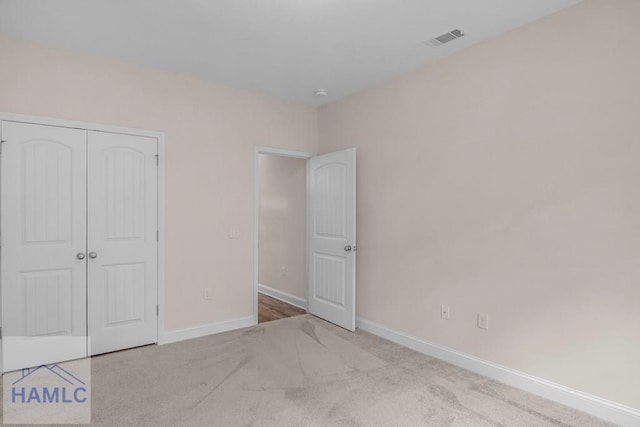 791 Stafford Dairy Rd SE, Ludowici, GA 31316 - unfurnished bedroom featuring baseboards, carpet flooring, and a closet