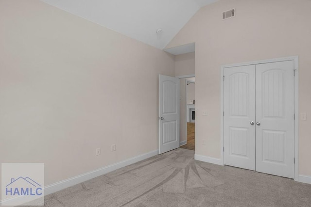 791 Stafford Dairy Rd SE, Ludowici, GA 31316 - unfurnished bedroom with carpet flooring, baseboards, a closet, and high vaulted ceiling