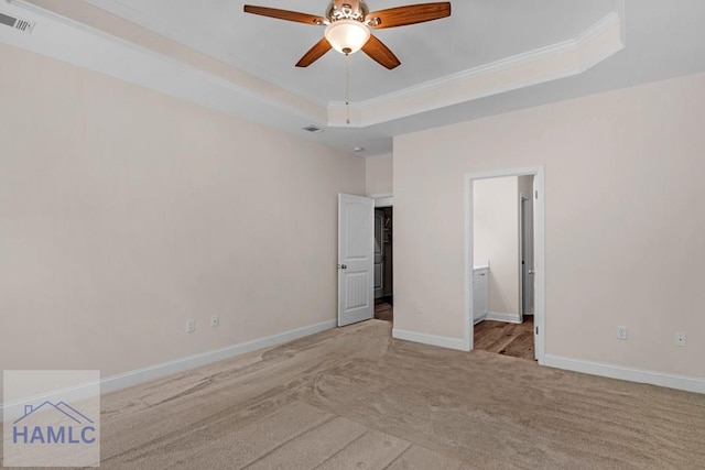 791 Stafford Dairy Rd SE, Ludowici, GA 31316 - unfurnished bedroom with carpet floors, a raised ceiling, baseboards, connected bathroom, and ornamental molding