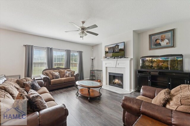 263NE Summer Hill Dr, Ludowici, GA 31316 - living area with ceiling fan, wood finished floors, a tile fireplace, and baseboards