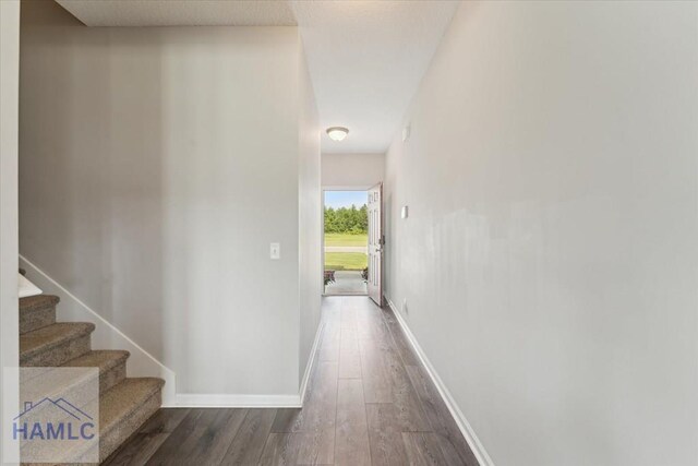 263NE Summer Hill Dr, Ludowici, GA 31316 - corridor featuring dark wood-style floors, stairs, and baseboards