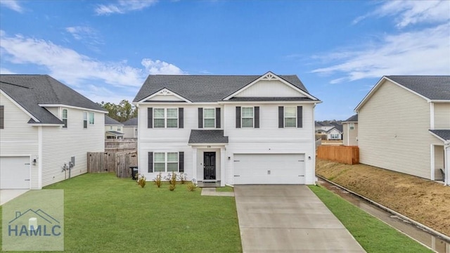 view of front of home featuring a front yard and a garage