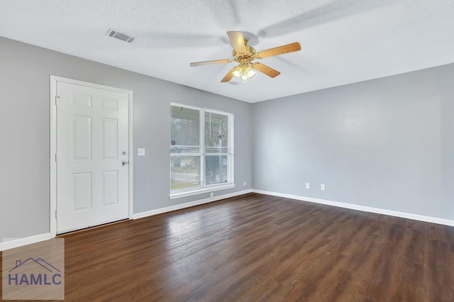 unfurnished room featuring ceiling fan, dark hardwood / wood-style flooring, and a textured ceiling