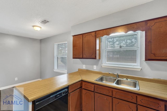 kitchen featuring kitchen peninsula, sink, a textured ceiling, and black dishwasher