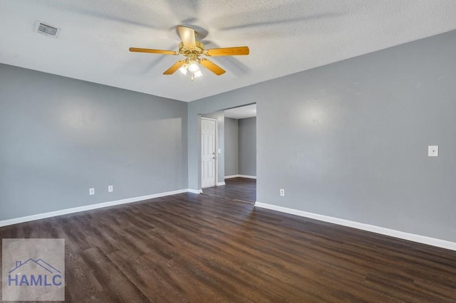 empty room featuring ceiling fan, dark hardwood / wood-style flooring, and a textured ceiling