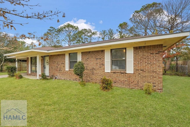 ranch-style home featuring a front yard