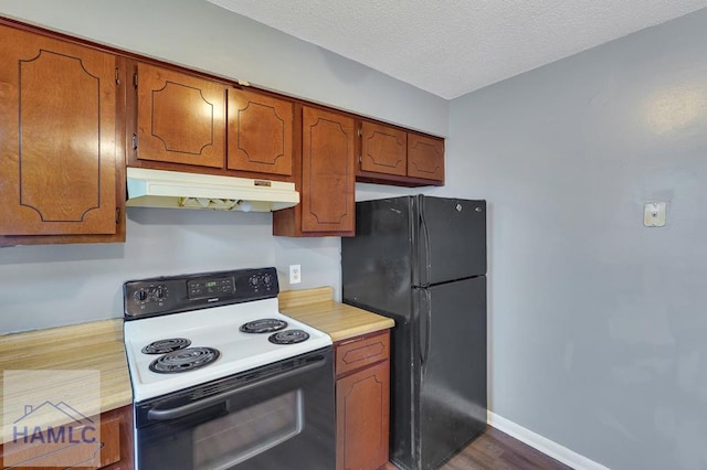 kitchen featuring black refrigerator, a textured ceiling, white electric stove, and dark wood-type flooring