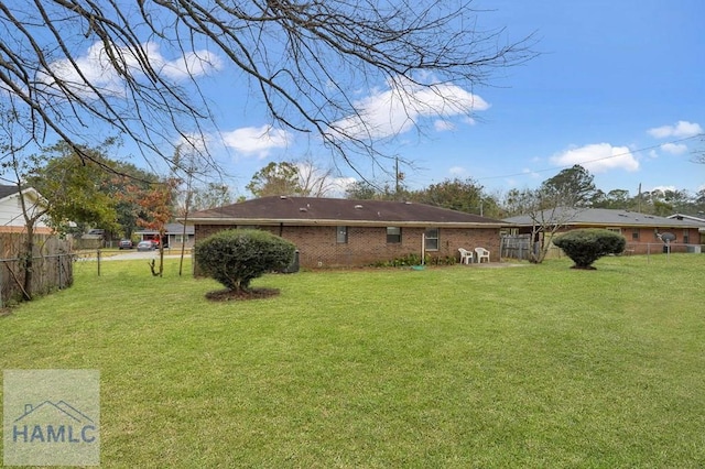 rear view of house with a yard