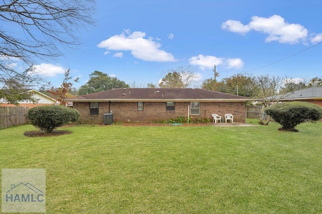 back of property featuring a lawn and a patio