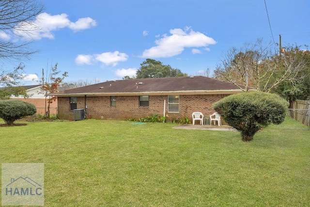 back of property with cooling unit, a patio area, and a yard