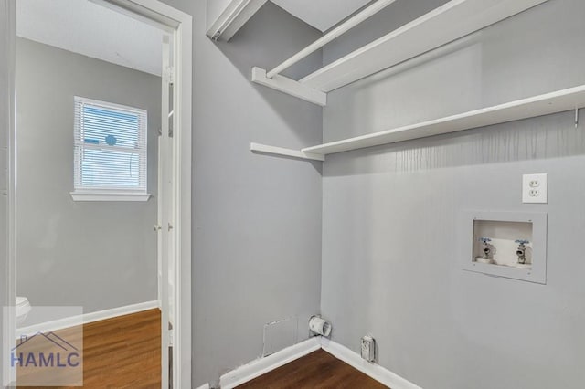 clothes washing area featuring washer hookup and hardwood / wood-style flooring