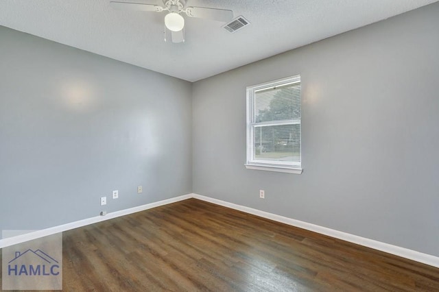 unfurnished room with ceiling fan, dark hardwood / wood-style flooring, and a textured ceiling