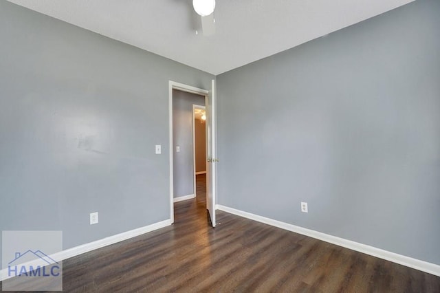 empty room with dark hardwood / wood-style flooring and ceiling fan