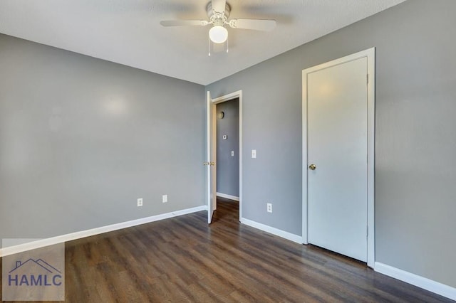 unfurnished bedroom featuring ceiling fan and dark wood-type flooring