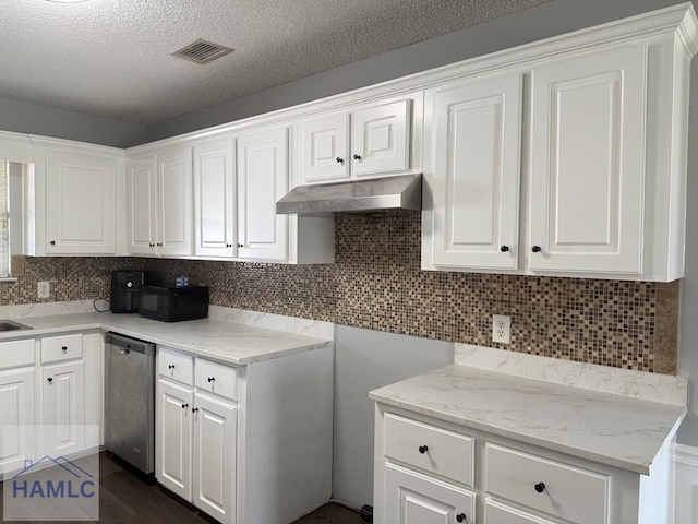 1021 Barley Dr, Hinesville, GA 31313 - kitchen with dishwasher, under cabinet range hood, black microwave, white cabinetry, and a textured ceiling