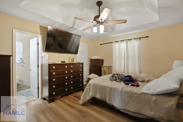 1267 Louise Ln, Hinesville, GA 31313 - bedroom featuring wood finished floors, ceiling fan, a textured ceiling, and ensuite bath