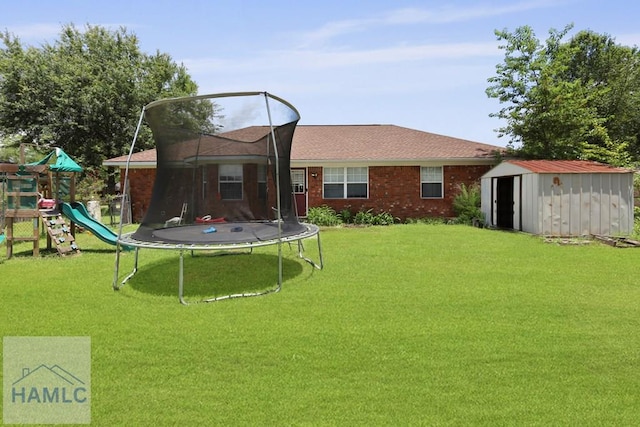 1267 Louise Ln, Hinesville, GA 31313 - back of house with a trampoline, a shed, a yard, and a playground