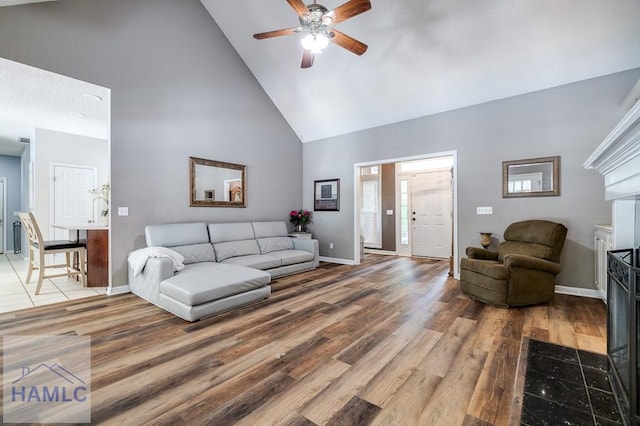 202 Red Bluff Cir, Rincon, GA 31326 - living room featuring high vaulted ceiling, ceiling fan, wood finished floors, and a fireplace with flush hearth