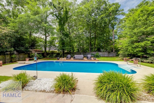 202 Red Bluff Cir, Rincon, GA 31326 - view of swimming pool featuring a fenced backyard, view of wooded area, and a patio
