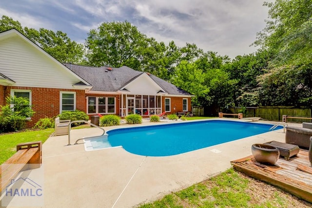 202 Red Bluff Cir, Rincon, GA 31326 - view of swimming pool with a sunroom, a fenced backyard, a patio area, view of scattered trees, and a diving board