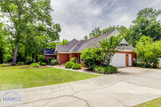 202 Red Bluff Cir, Rincon, GA 31326 - view of front of home featuring driveway, brick siding, a garage, and a front lawn