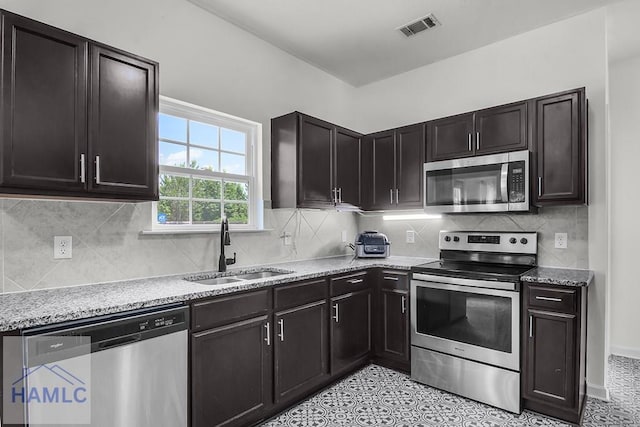 134 Dove Run Dr NE, Ludowici, GA 31316 - kitchen with stainless steel appliances, light stone countertops, and tasteful backsplash