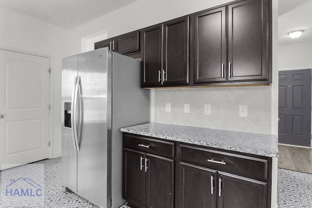 134 Dove Run Dr NE, Ludowici, GA 31316 - kitchen featuring stainless steel refrigerator with ice dispenser, tasteful backsplash, and light stone counters